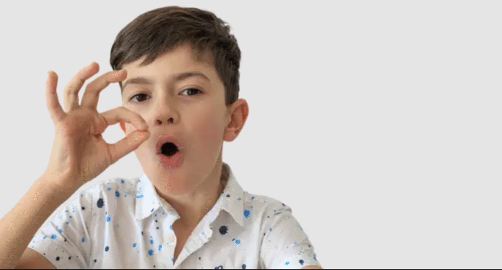 Sensory-Friendly Kids Haircut Boy with OK Sign Pasadena Well-groomed boy smiling and showing an OK sign after a sensory-friendly haircut at The Great Bear Cut in Pasadena